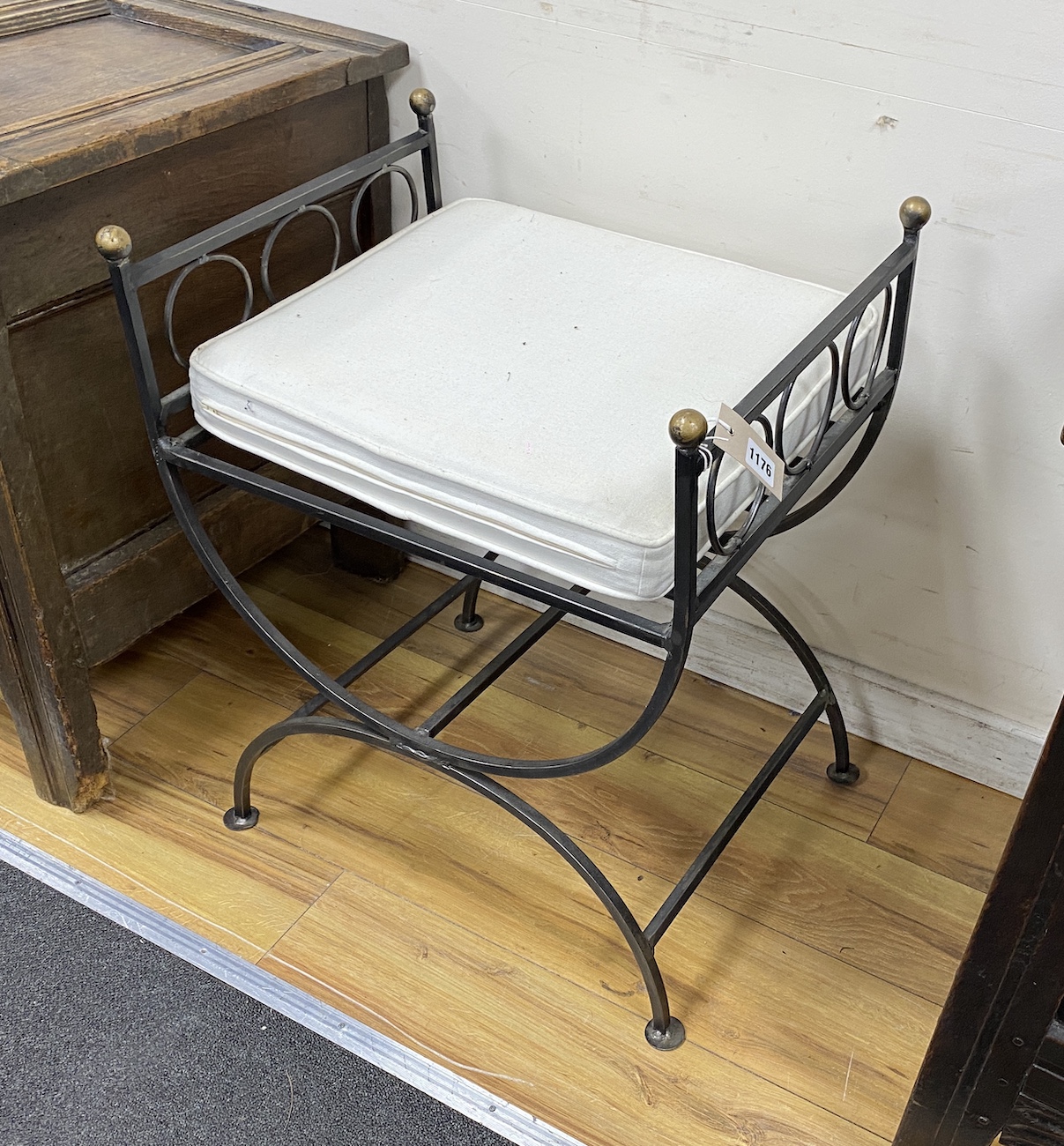 A pair of wrought iron ‘’X’’ framed stools, width 50cm, depth 42cm, height 66cm